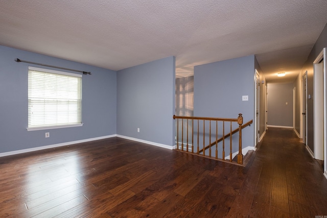 3400 Millbrook Rd, Little Rock, AR 72227 - empty room featuring dark wood-style floors, baseboards, and a textured ceiling