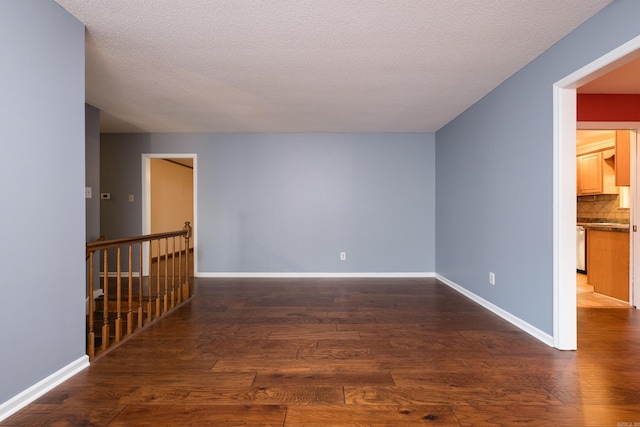 3400 Millbrook Rd, Little Rock, AR 72227 - empty room with wood finished floors, baseboards, and a textured ceiling