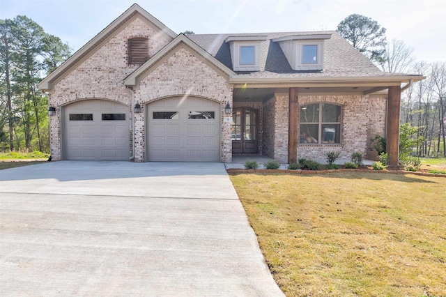 9 Quartz Cv, Little Rock, AR 72223 - view of front of property featuring brick siding, an attached garage, driveway, a front lawn, and french doors