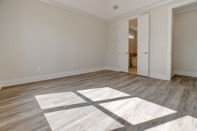 9 Quartz Cv, Little Rock, AR 72223 - unfurnished bedroom with wood finished floors, baseboards, and ornamental molding
