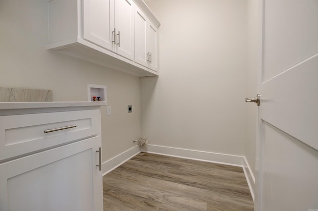 9 Quartz Cv, Little Rock, AR 72223 - laundry area with electric dryer hookup, washer hookup, light wood-type flooring, baseboards, and cabinet space