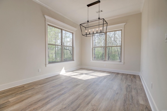 9 Quartz Cv, Little Rock, AR 72223 - spare room with a chandelier, plenty of natural light, crown molding, wood finished floors, and baseboards
