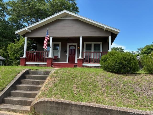 1016 W Elm St, El Dorado, AR 71730 - view of front of house with a porch, a front yard, and crawl space