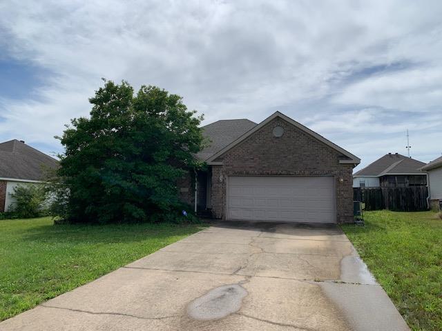4709 Summit Rdg, Jonesboro, AR 72404 - view of front of house with driveway, brick siding, a front yard, and an attached garage