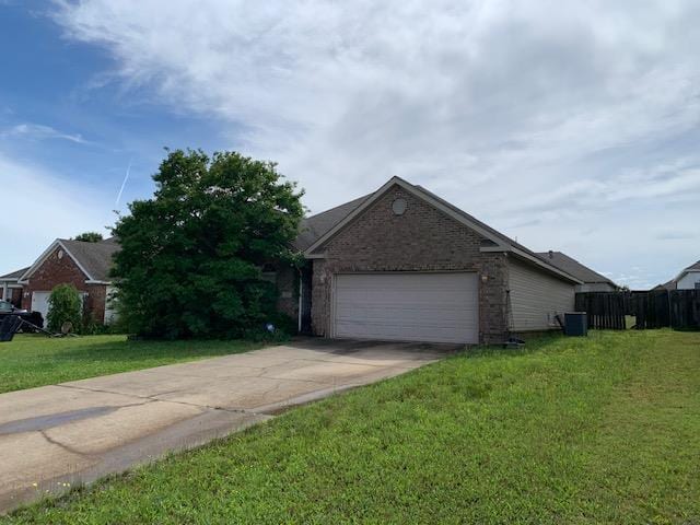 4709 Summit Rdg, Jonesboro, AR 72404 - view of front of home featuring brick siding, an attached garage, driveway, a front yard, and central air condition unit