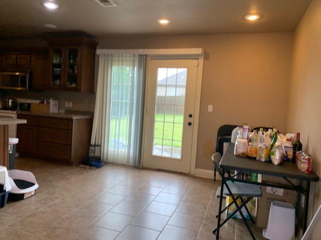 4709 Summit Rdg, Jonesboro, AR 72404 - doorway with healthy amount of natural light, recessed lighting, light tile patterned floors, and baseboards