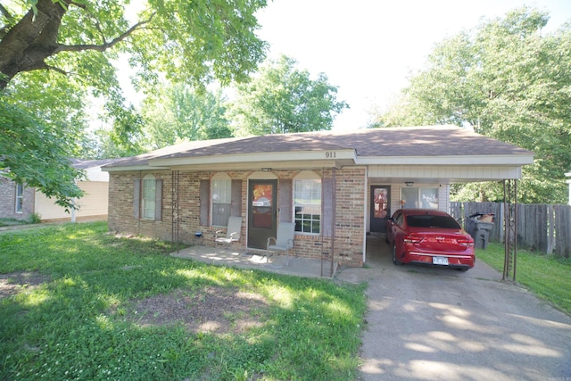 single story home featuring brick siding, driveway, a carport, and covered porch