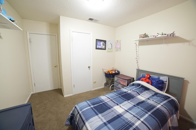 carpeted bedroom featuring a textured ceiling