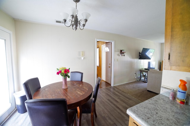 dining room with a chandelier and wood finished floors