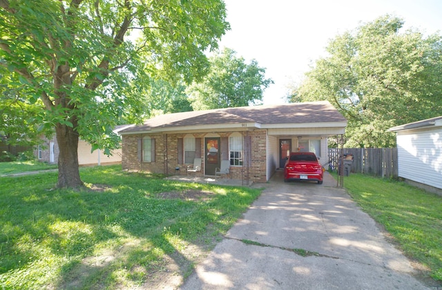 ranch-style house featuring driveway, brick siding, and a carport