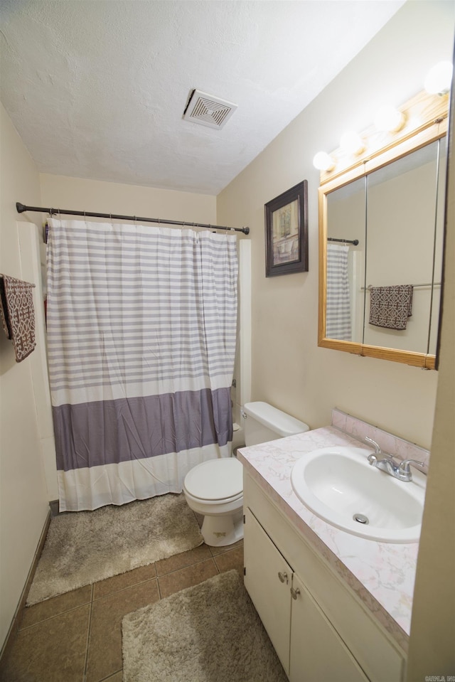 bathroom featuring toilet, vanity, tile patterned floors, and a shower with shower curtain