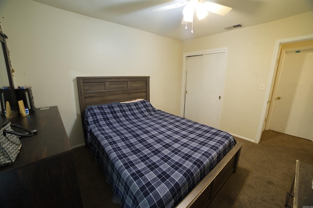 carpeted bedroom featuring ceiling fan, a closet, and baseboards