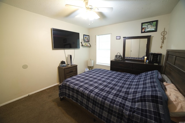 carpeted bedroom featuring ceiling fan and baseboards