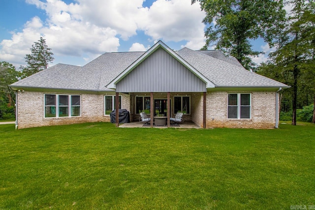 1125 Lisa Ln, Conway, AR 72034 - back of property featuring roof with shingles, a lawn, a patio area, and brick siding