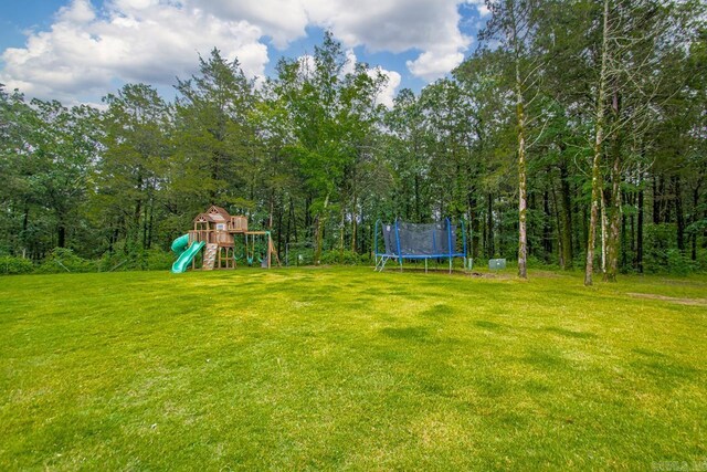 1125 Lisa Ln, Conway, AR 72034 - view of green lawn with a trampoline and a playground