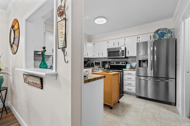 160 Cooper St Unit B11, Hot Springs, AR 71913 - kitchen featuring stainless steel appliances, crown molding, tasteful backsplash, white cabinetry, and butcher block counters