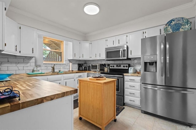 160 Cooper St Unit B11, Hot Springs, AR 71913 - kitchen with appliances with stainless steel finishes, wood counters, ornamental molding, backsplash, and white cabinetry