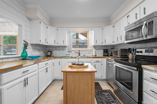160 Cooper St Unit B11, Hot Springs, AR 71913 - kitchen featuring stainless steel appliances, butcher block countertops, a sink, tasteful backsplash, and crown molding