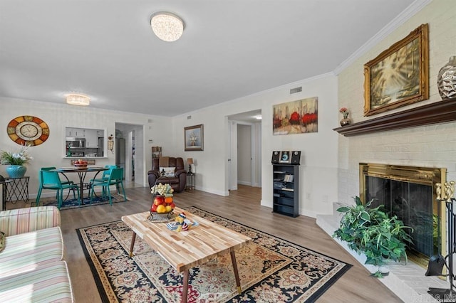 160 Cooper St Unit B11, Hot Springs, AR 71913 - living room featuring wood finished floors, baseboards, a fireplace, and ornamental molding