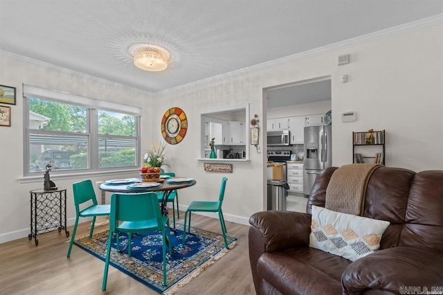 160 Cooper St Unit B11, Hot Springs, AR 71913 - dining space with light wood-style floors, ornamental molding, and baseboards