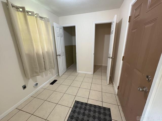 1002 W 3rd St, Rector, AR 72461 - bathroom with tile patterned flooring and baseboards
