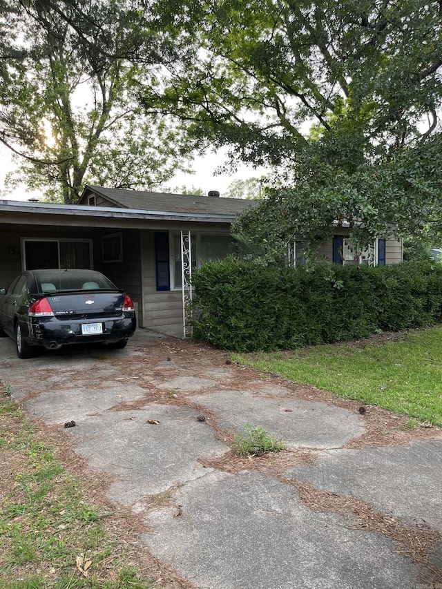 720 Depot St, Lonoke, AR 72086 - view of front of property with asphalt driveway and a carport