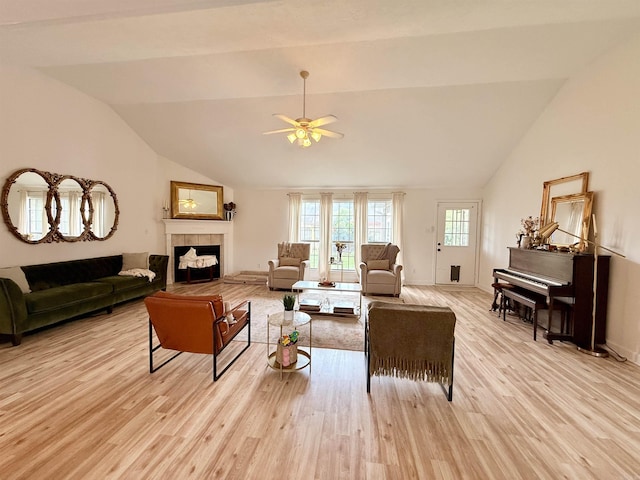 7 Butterfly Dr, Sherwood, AR 72120 - living area featuring vaulted ceiling, light wood finished floors, a ceiling fan, a fireplace, and baseboards