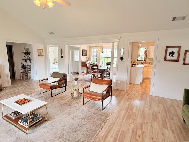 7 Butterfly Dr, Sherwood, AR 72120 - living room with light wood-type flooring, lofted ceiling, ceiling fan, and a chandelier