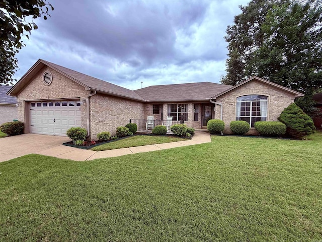 7 Butterfly Dr, Sherwood, AR 72120 - ranch-style home with brick siding, an attached garage, a front yard, driveway, and covered porch