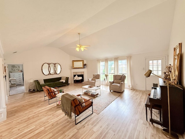7 Butterfly Dr, Sherwood, AR 72120 - living area with vaulted ceiling, light wood-style flooring, healthy amount of natural light, a ceiling fan, and a tiled fireplace