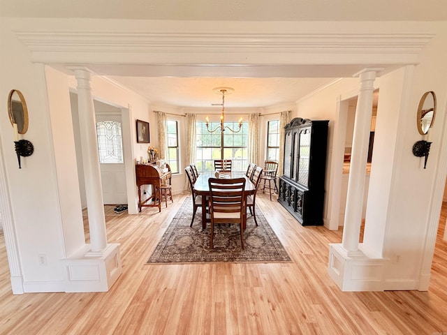 7 Butterfly Dr, Sherwood, AR 72120 - dining room featuring light wood-type flooring, ornamental molding, a chandelier, decorative columns, and baseboards