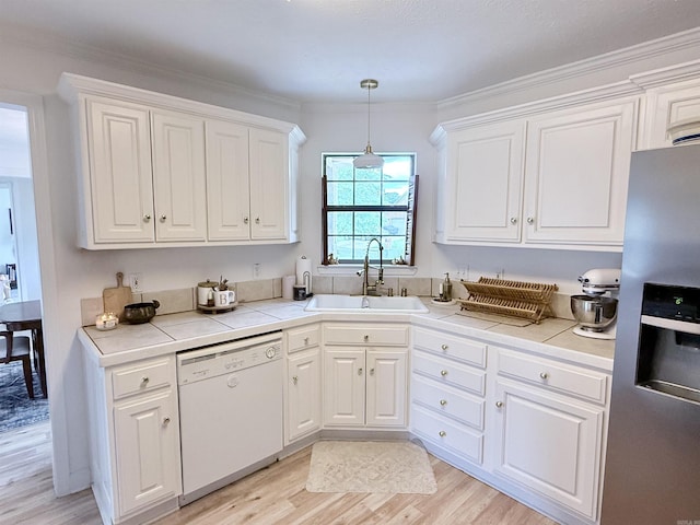 7 Butterfly Dr, Sherwood, AR 72120 - kitchen with white dishwasher, stainless steel fridge, a sink, white cabinets, and light wood finished floors