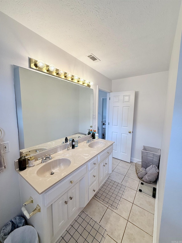 7 Butterfly Dr, Sherwood, AR 72120 - bathroom featuring double vanity, tile patterned floors, and a textured ceiling