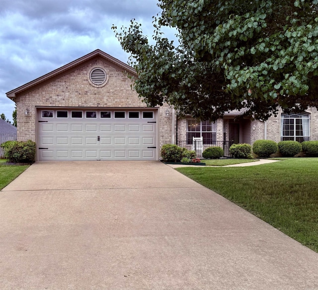 7 Butterfly Dr, Sherwood, AR 72120 - ranch-style home featuring concrete driveway, a front lawn, brick siding, and a garage