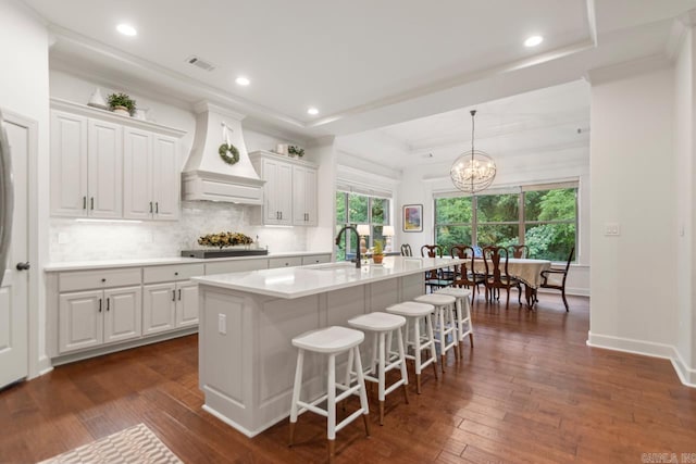1517 Wetherborne Dr, Little Rock, AR 72211 - kitchen with custom exhaust hood, a sink, light countertops, backsplash, and recessed lighting