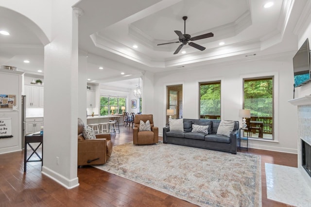 1517 Wetherborne Dr, Little Rock, AR 72211 - living area with arched walkways, ornamental molding, a ceiling fan, a premium fireplace, and a raised ceiling