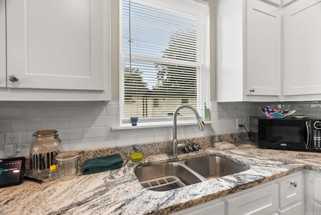 1 Park St Unit A & B, Mayflower, AR 72106 - kitchen featuring black microwave, a sink, white cabinets, backsplash, and light stone countertops