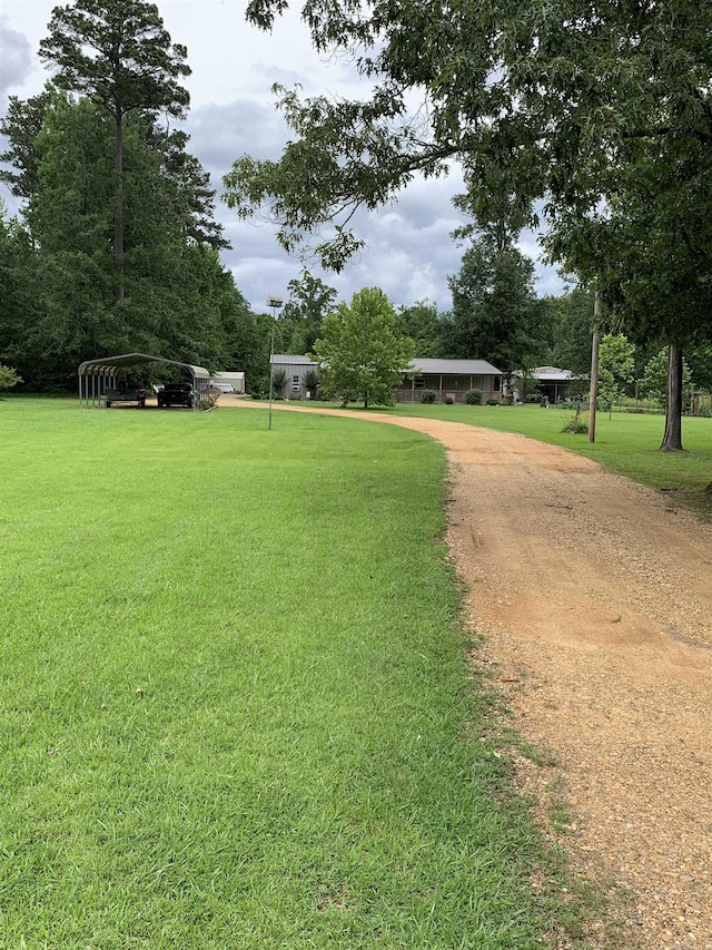 160 Ouachita 476, Camden, AR 71701 - view of home's community with a detached carport, dirt driveway, and a yard