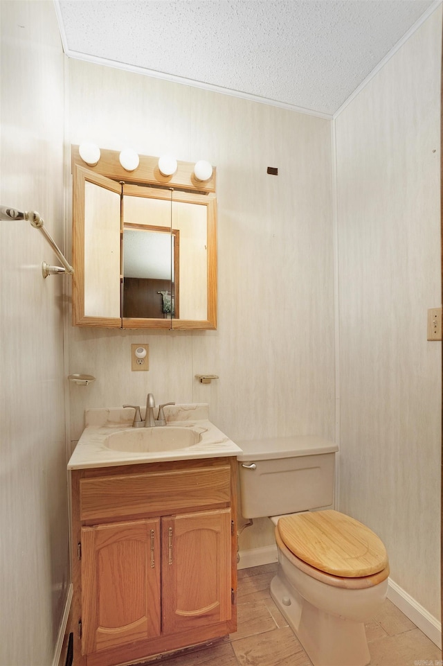 23 Valls Ln, Hot Springs, AR 71909 - bathroom featuring a textured ceiling, toilet, crown molding, vanity, and baseboards