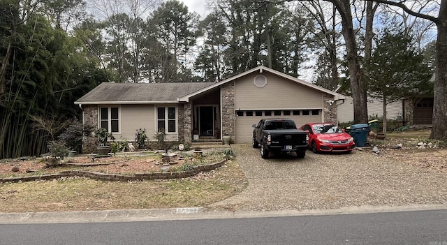 17003 Quail Run Dr, Little Rock, AR 72210 - view of front of house featuring stone siding, driveway, and an attached garage