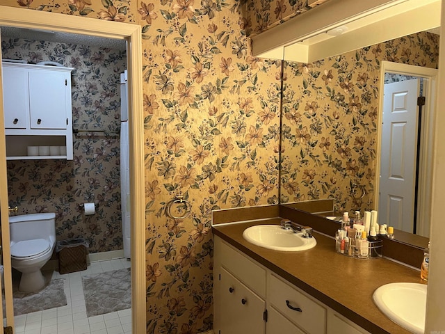 17003 Quail Run Dr, Little Rock, AR 72210 - bathroom featuring wallpapered walls, tile patterned flooring, double vanity, toilet, and baseboards