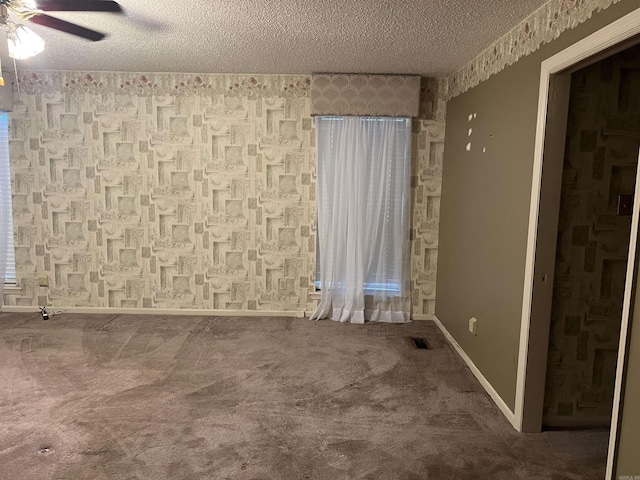 17003 Quail Run Dr, Little Rock, AR 72210 - spare room featuring a ceiling fan, a textured ceiling, carpet floors, wallpapered walls, and baseboards