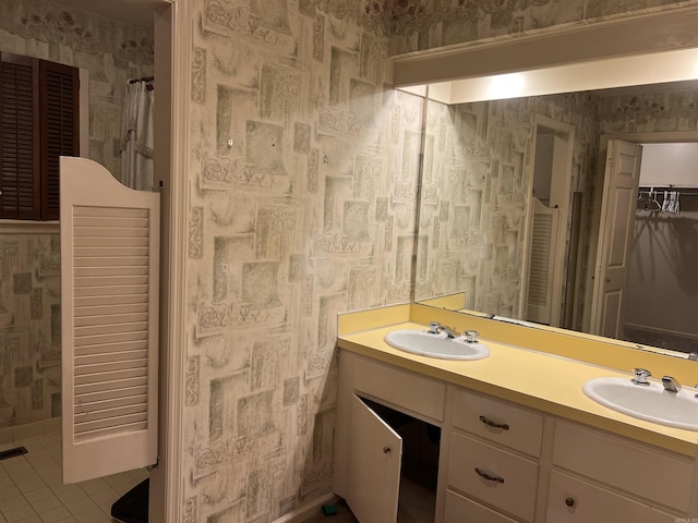 17003 Quail Run Dr, Little Rock, AR 72210 - bathroom featuring wallpapered walls, a closet, tile patterned floors, and double vanity