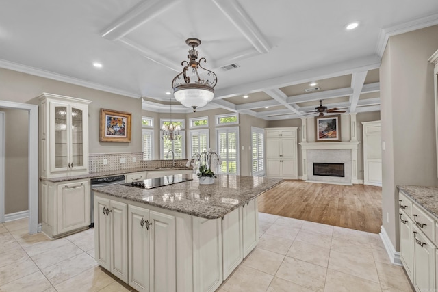 119 Marseille Dr, Maumelle, AR 72113 - kitchen featuring ceiling fan, a kitchen island with sink, a fireplace, black electric cooktop, and recessed lighting