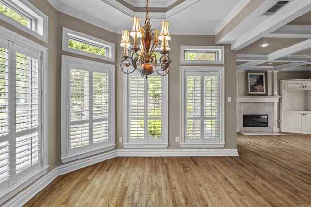 119 Marseille Dr, Maumelle, AR 72113 - unfurnished dining area featuring a chandelier, baseboards, crown molding, wood finished floors, and plenty of natural light