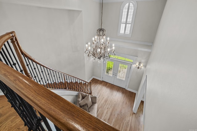 119 Marseille Dr, Maumelle, AR 72113 - foyer entrance with a chandelier, stairs, french doors, baseboards, and wood finished floors