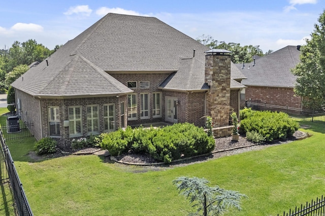 119 Marseille Dr, Maumelle, AR 72113 - rear view of house featuring brick siding, central AC unit, a shingled roof, and a chimney