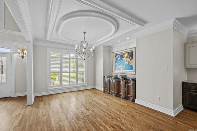 119 Marseille Dr, Maumelle, AR 72113 - unfurnished dining area with a chandelier, baseboards, wood finished floors, a tray ceiling, and ornamental molding