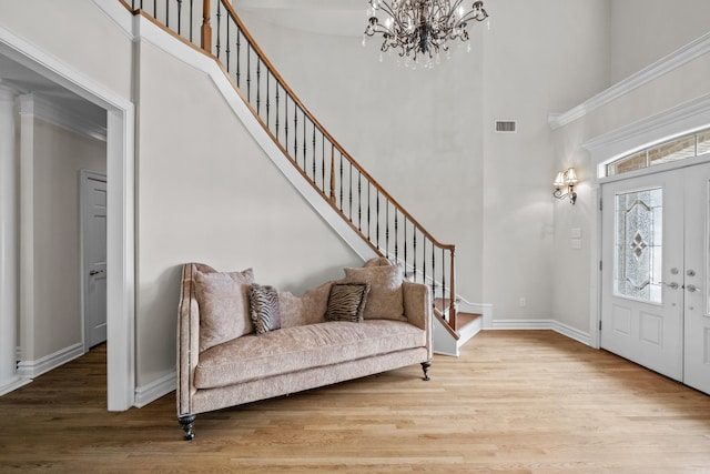 119 Marseille Dr, Maumelle, AR 72113 - foyer entrance with a towering ceiling, a chandelier, wood finished floors, baseboards, and stairs