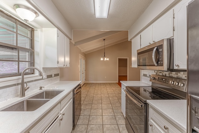 1655 Doe Trl, Conway, AR 72034 - kitchen featuring stainless steel appliances, a sink, tasteful backsplash, vaulted ceiling, and white cabinetry
